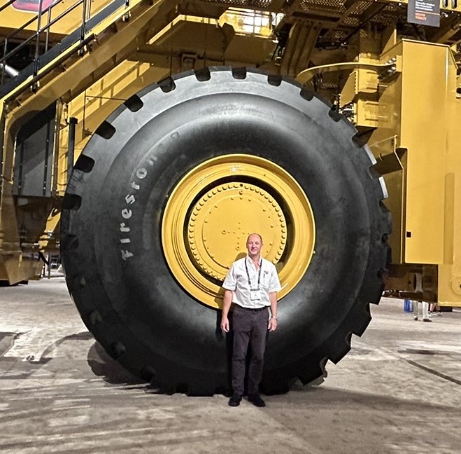 Steve stood infront a large tyre